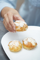 Woman eating eclairs