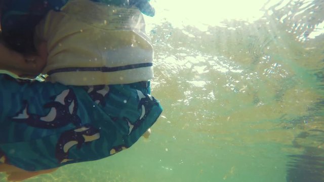 Toddler swimming in the ocean water