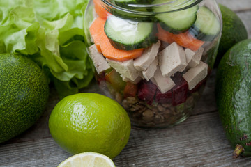 healthy salad with beets, tofu, cucumber, carrots, lentils, peas, garlic and avocado in the bank. detox and green vegetables every day.