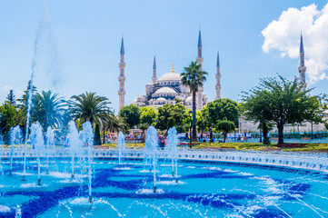 The Sultan Ahmed Mosque (Blue Mosque) and fountain view from the Sultanahmet Park in Istanbul, Turkey