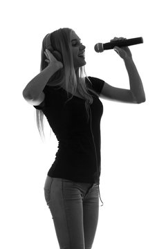 portrait of a beautiful woman in headphones and with a microphone