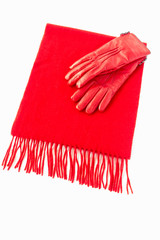 Luxurious red cashmere scarf out of pure cashmere wool and warm leather gloves isolated on white background. 
