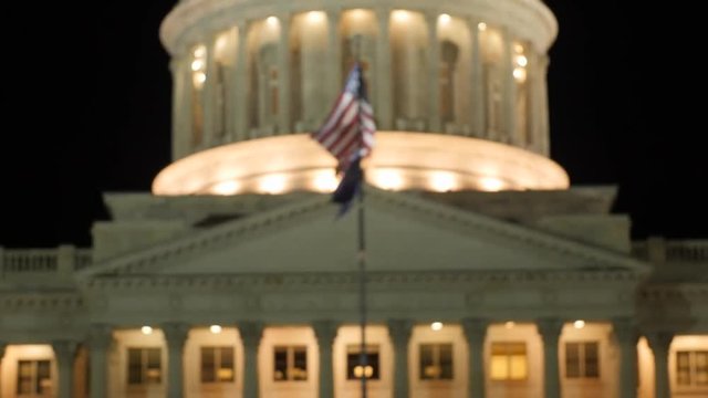 Flag flies at the Utah State Capitol at night rack shot