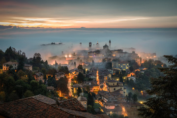 Bergamo through the fog at dawn - obrazy, fototapety, plakaty