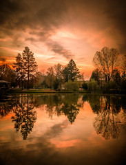 Beautiful autumn landscape. Sunset over a forest lake.