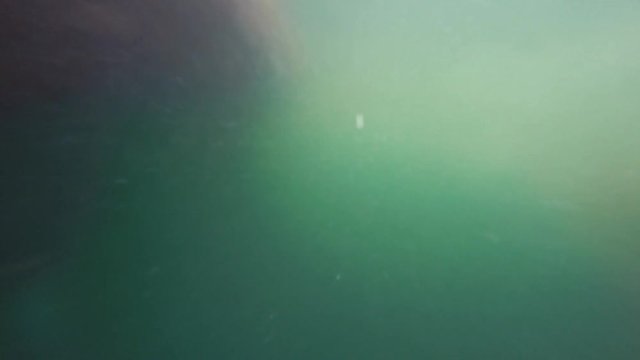 An underwater shot of bubbles passing by boat hull while parking
