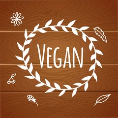 Vegan product label. World vegan day. Hand drawn rustic frame with flowers and leaves on wood background. Typography design. Vegan.