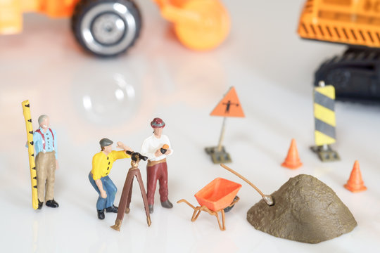Construction toy / View of construction site of mini toy worker on white background.