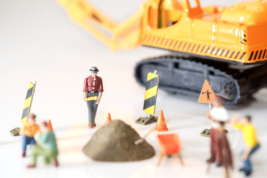 Construction toy / View of construction site of mini toy worker on white background.