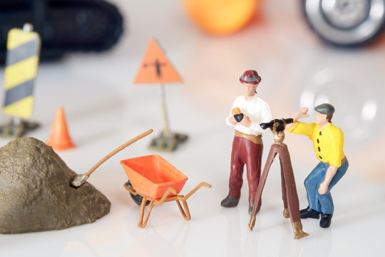 Construction toy / View of construction site of mini toy worker on white background.