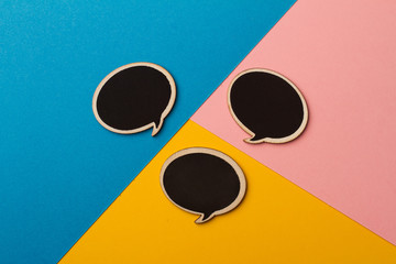 Round empty chalk board speech bubbles on colored papers