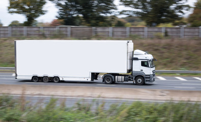 Large white double decker lorry on the british motorway