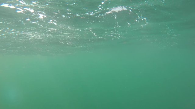 Underwater shot of beautiful rough ocean waves on surface