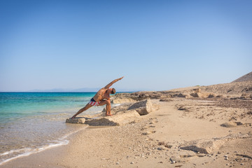 Adult man on the beach, morning yoga practice