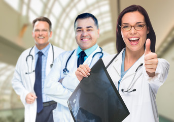 Fototapeta premium Doctors or Nurses With Thumbs Up Holding X-ray Standing Inside Hospital.