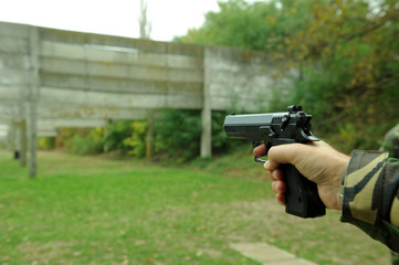 Man holding a pistol in his hands, ready to shoot