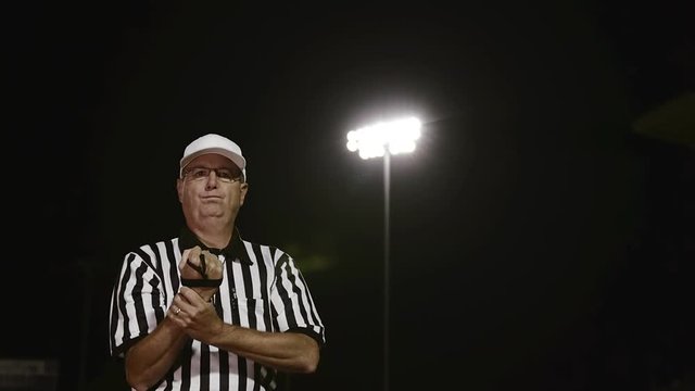 A football referee gives a penalty hand signal