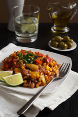 Warm vegetable salad with lime on a white plate