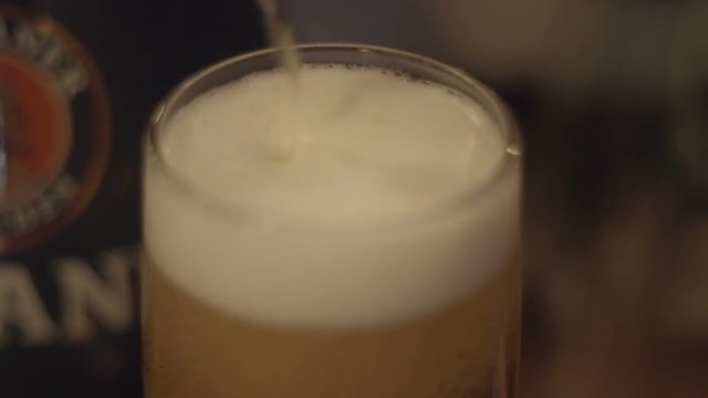 Beer is poured into a glass