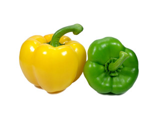 Close-up of two ripe bright color bell peppers, one green and one yellow with green stem isolated...