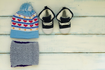 Set of baby winter clothes including a hat, scarf and shoes