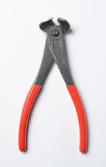 Pliers with red handles on a white background