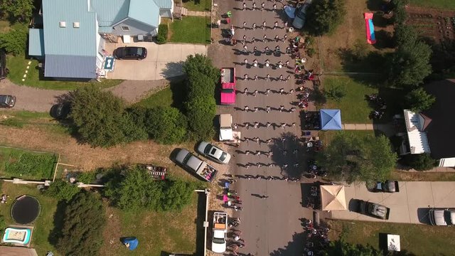 Aerial dolly shot of marching band in a july 4th parade