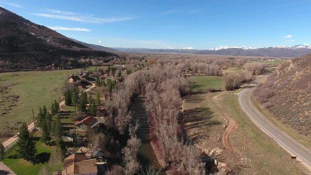 Aerial shot of houses along a river in a rural town