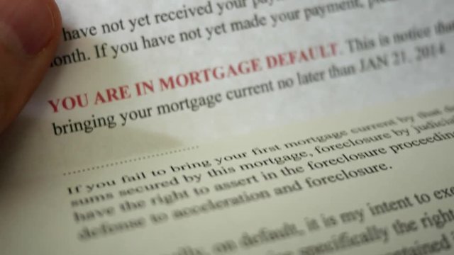 Man reading final notice foreclosure letter from bank