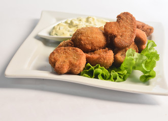Mushrooms fried on a white plate.