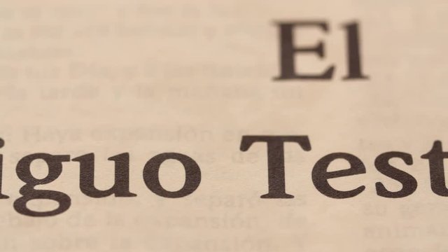 A closeup dolly shot of Old Testament in Spanish