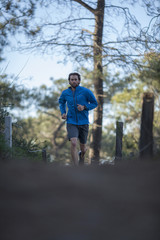 Fototapeta premium An adult man running trail at Torrey Pines State Park. San Diego, California.