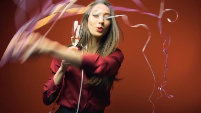 a new year party brunette girl having fun with bocal of champaign