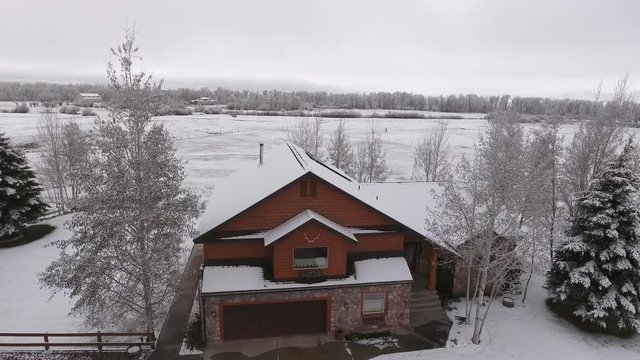 Aerial shot of a house in the winter time after snow storm