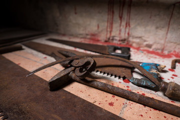 Close up of saws, sickles, hammer and other devices on the blood