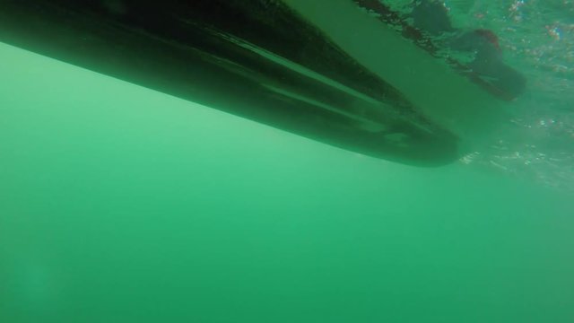 Underwater shot of zodiak raft boat on rough ocean waves