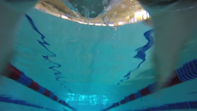 Underwater FPV shot of man swimming the breast stroke