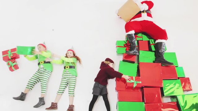 Santa's helpers working at North Pole. He Reading wishes list