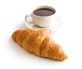 Tasty buttery croissant and cup of coffee.