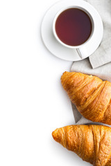 Tasty buttery croissant and cup of tea.