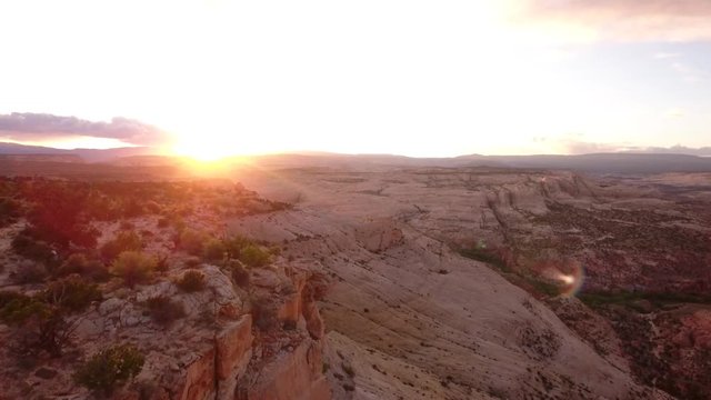 An aerial shot of woman and desert sunset landscape