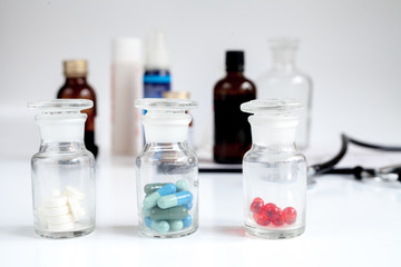 glass jars of pills - home first aid kit