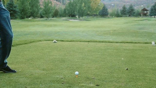 Slow motion of man driving the golf ball on the course