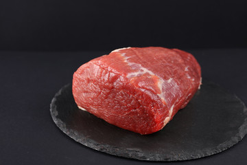 Raw beef meat steak in black background. Cooking , healthy eating concept.