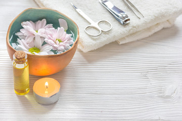 spa nail care with tea candle on wooden background