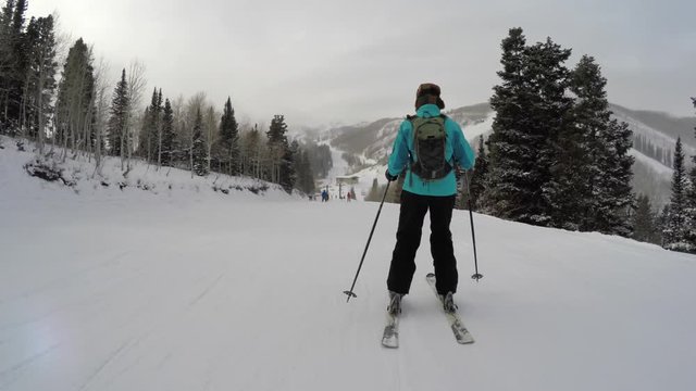 Woman skiing at a mountain resort on a cold winter day