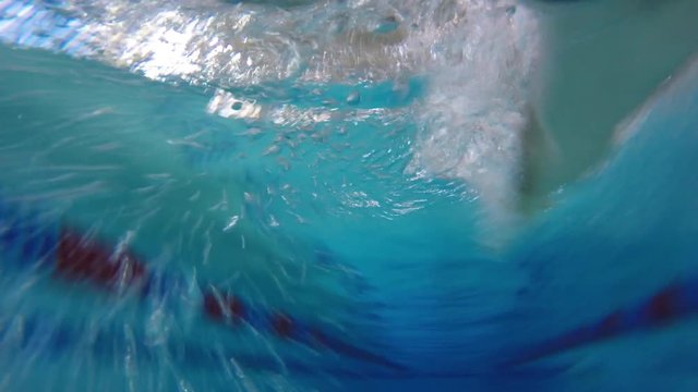 Underwater FPV shot of man swimming front crawl