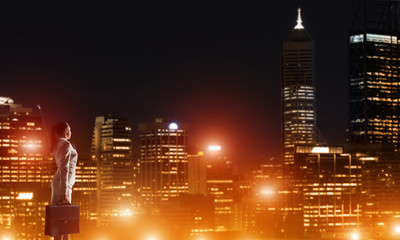 Woman looking at night city