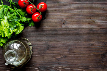 tomato, rosemary and garlic on dark wooden background top view