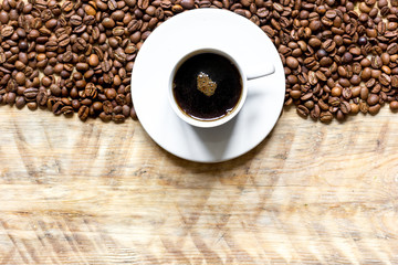 coffee beans on wooden with coffe cup table top view